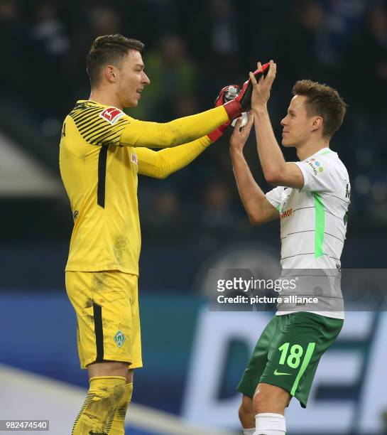 Bremen goalie Jiri Pavlenka and Niklas Moisander celebrate the 1:2 win in the German Bundesliga football match between FC Schalke 04 and Werder...