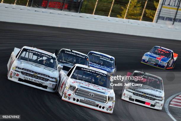 Todd Gilliland, driver of the Royal Canin Toyota, and Justin Haley, driver of the Fraternal Order Of Eagles Chevrolet, lead a pack of trucks during...