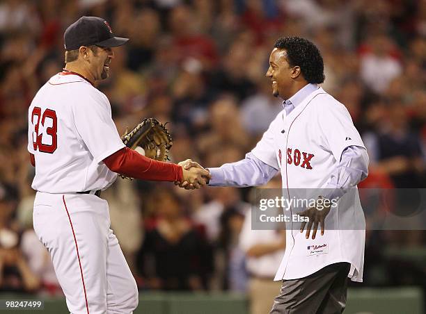 Jason Varitek of the Boston Red Sox greets Pedro Martinez after Martinez threw out the ceremonial first pitch before the game against the New York...