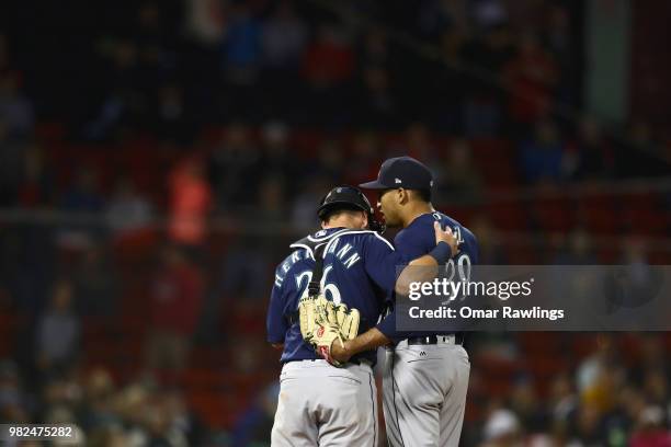 Chris Herrmann of the Seattle Mariners visits Edwin Diaz of the Seattle Mariners on the mound in the bottom of the ninth inning of the game against...