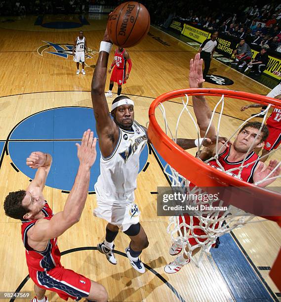 Andray Blatche of the Washington Wizards shoots against Kris Humphries and Brook Lopez of the New Jersey Nets at the Verizon Center on April 4, 2010...