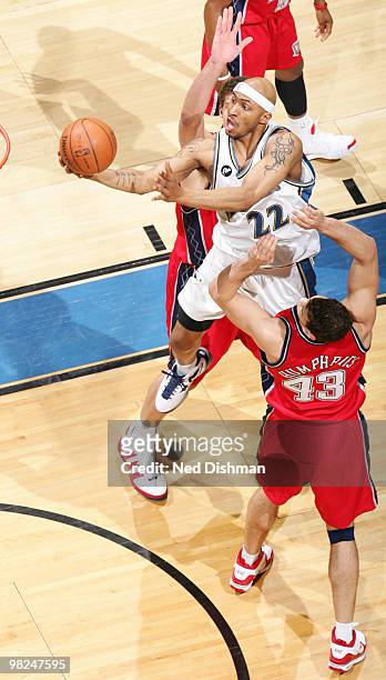 James Singleton of the Washington Wizards shoots against Kris Humphries of the New Jersey Nets at the Verizon Center on April 4, 2010 in Washington,...