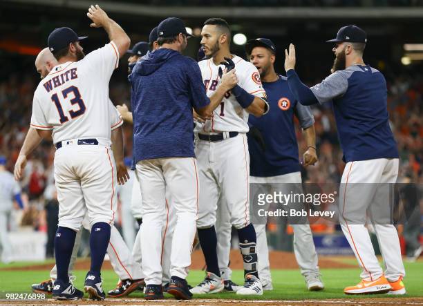 Carlos Correa of the Houston Astros celebrates with this teammates after hitting a walkoff single in the twelfth inning for a 4-3 win over thte...