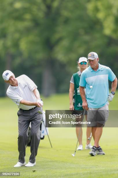 Andy North chips on while Bret Favre looks on during the American Family Insurance Championship Champions Tour golf tournament on June 23, 2018 at...