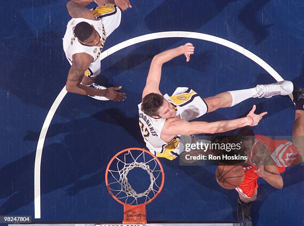 Jared Jeffries of the Houston Rockets battles Josh McRoberts and Soloman Jones of the Indiana Pacers at Conseco Fieldhouse on April 4, 2010 in...