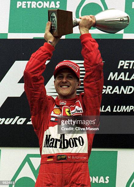 Michael Schumacher of Germany and the Ferrari Formula One Team, celebrates his victory at the Malaysian Grand Prix at the Sepang International...