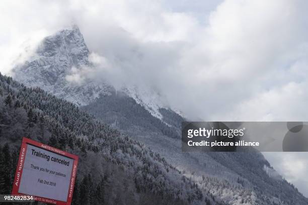 Sign in front of the Waxenstein mountains announces that the training session for women athletes at the alpine skiing World Cup was cancelled due to...