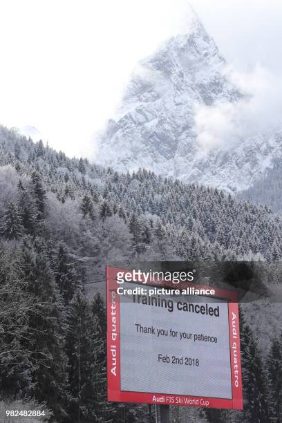Sign in front of the Waxenstein mountains announces that the training session for women athletes at the alpine skiing World Cup was cancelled due to...
