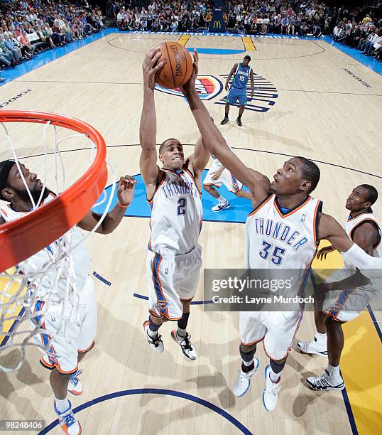 James Harden, Thabo Sefolosha and Kevin Durant, all of the Oklahoma City Thunder go up for a rebound during the game against the Minnesota...