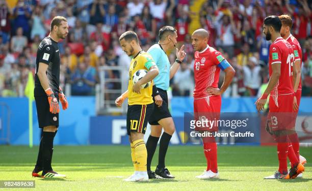 Eden Hazard of Belgium gets ready to shoot a penalty while goalkeeper of Tunisia Farouk Ben Mustapha looks on and referee Jair Marrufo of USA talks...