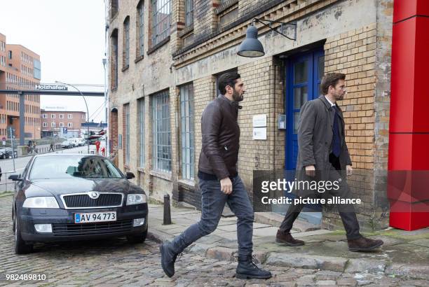 The Lebanese-Swedish actor Fares Fares and the Danish actor Nikolaj Lie Kaas pass a car at the corner of Sandberg/Grosse Elbstrasse during the...