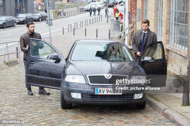 The Lebanese-Swedish actor Fares Fares and the Danish actor Nikolaj Lie Kaas pass a car at the corner of Sandberg/Grosse Elbstrasse during the...