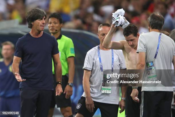 Sebastian Rudy of Germany recats next to head coach Joachim Loew following an injury during the 2018 FIFA World Cup Russia group F match between...