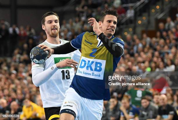 Germany's Hendrik Pekeler in action against All Star's Andy Schmid during the All Star Game 2018 handball match between the All Star Team and...