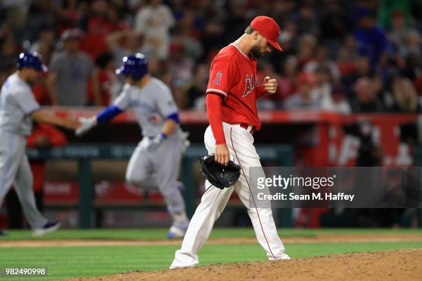 Steve Pearce of the Toronto Blue Jays rounds third base after hitting a three-run homerun as Justin Anderson of the Los Angeles Angels of Anaheim...