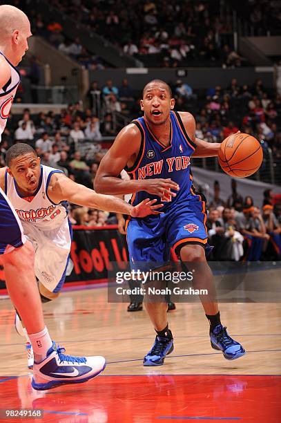 Chris Duhon of the New York Knicks dribbles against Eric Gordon of the Los Angeles Clippers at Staples Center on April 4, 2010 in Los Angeles,...