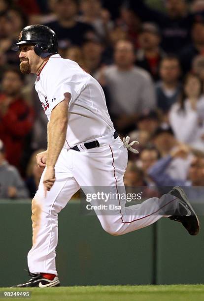 Kevin Youkilis of the Boston Red Sox score the game winning run against the New York Yankees on April 4, 2010 during Opening Night at Fenway Park in...