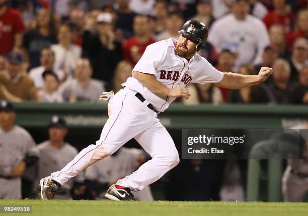 Kevin Youkilis of the Boston Red Sox heads back to third instead of stealing home against the New York Yankees on April 4, 2010 during Opening Night...