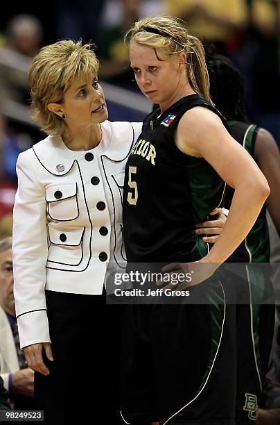 Melissa Jones of the Baylor Bears is consoled by head coach Kim Mulkey after fouling out in the second half against the Connecticut Huskies during...