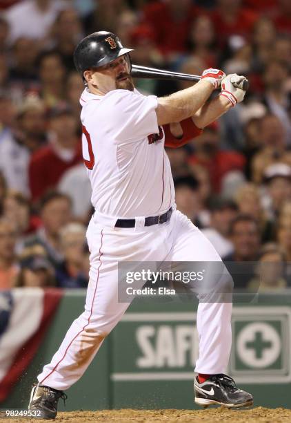Kevin Youkilis of the Boston Red Sox hits a triple against the New York Yankees on April 4, 2010 during Opening Night at Fenway Park in Boston,...