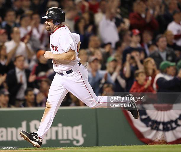 Kevin Youkilis of the Boston Red Sox scores a run against the New York Yankees on April 4, 2010 during Opening Night at Fenway Park in Boston,...
