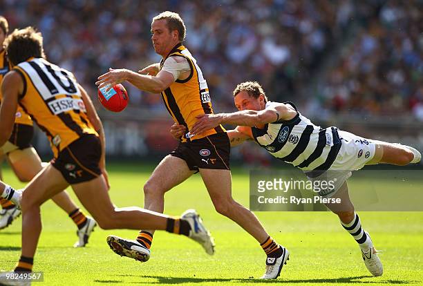 Rick Ladson of the Hawks is tackled by Josh Kelly of the Cats during the round two AFL match between the Hawthorn Hawks and the Geelong Cats at the...