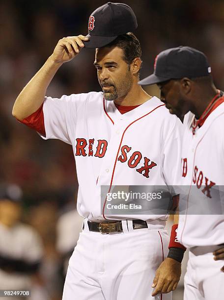 Mike Lowell of the Boston Red Sox tips his hat to the fans during player introductions before the game against the New York Yankees on April 4, 2010...