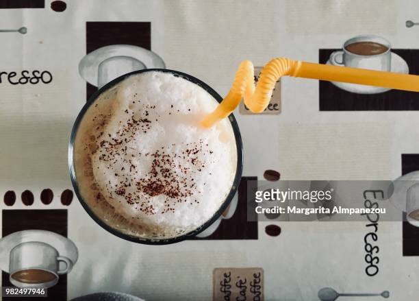 cappuccino freddo iced coffee with a straw - freddo stock pictures, royalty-free photos & images