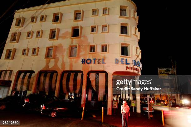 Man crosses the street in front of a darkened hotel as residents were left without power or running water after a 7.2 magnitude earthquake struck the...