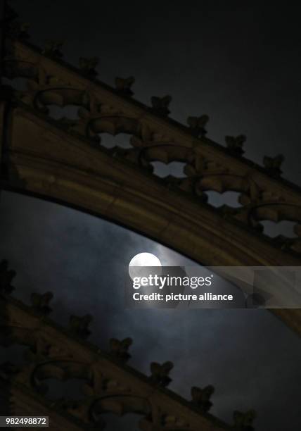 The full moon shines bright shortly after midnight, illuminating the Cathedral in Cologne, Germany, 1 February 2018. For the second time in a month...