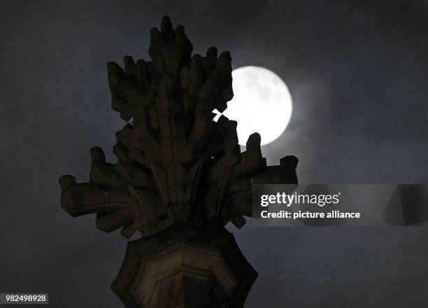 The full moon shines bright shortly after midnight, illuminating the Cathedral in Cologne, Germany, 1 February 2018. For the second time in a month...