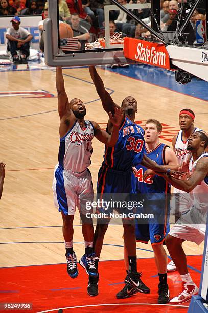 Baron Davis of the Los Angeles Clippers puts up a shot against Earl Barron of the New York Knicks at Staples Center on April 4, 2010 in Los Angeles,...