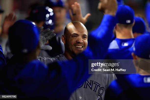 Steve Pearce of the Toronto Blue Jays is congratulated in the dugout after hitting a three-run homerun during the ninth inning of a game against the...