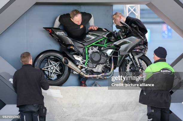 Several men position a Kawasaki H2R at the stand of the Japanese motorcycle builder Kawasaki, at the motorcycle fair in Leipzig, Germany, 1 February...