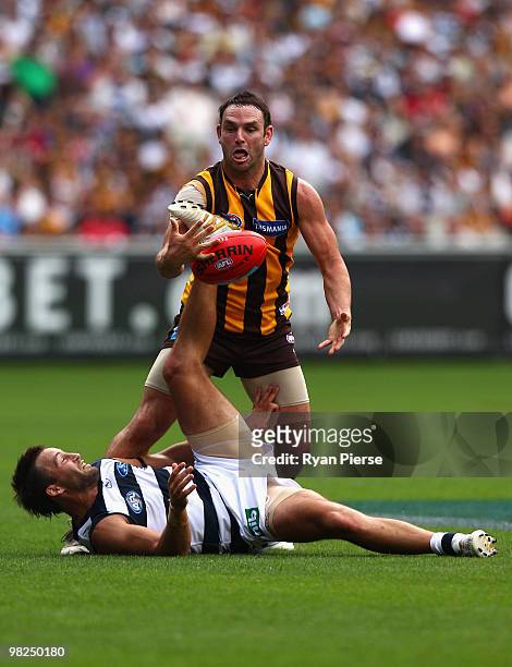 Brent Guerra of the Hawks competes for the ball against Jimmy Bartel of the Cats during the round two AFL match between the Hawthorn Hawks and the...