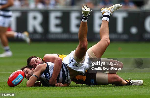 Brent Guerra of the Hawks tackles Jimmy Bartel of the Cats during the round two AFL match between the Hawthorn Hawks and the Geelong Cats at the...