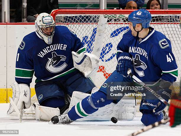 Andrew Alberts of the Vancouver Canucks looks on as Roberto Luongo makes a save during their game against the Minnesota Wild at General Motors Place...