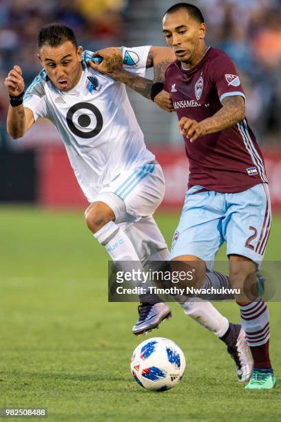 Miguel Ibarra of Minnesota United and Edgar Castillo of Colorado Rapids chase a loose ball at Dick's Sporting Goods Park on June 23, 2018 in Commerce...