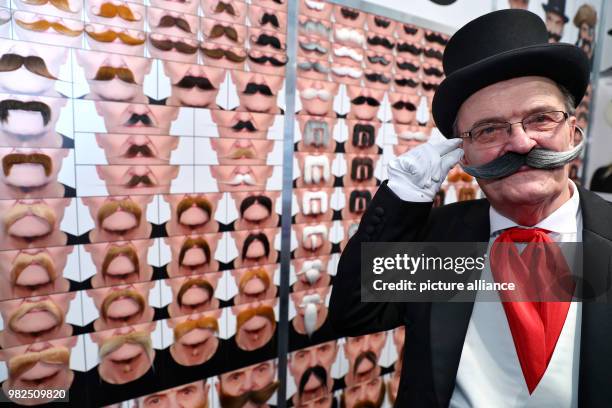 Danielius Zalieckas presents his fake mustache at the stand of the company "mustaches" from Lithuania, at the 69th Nuremberg International Toy Fair...