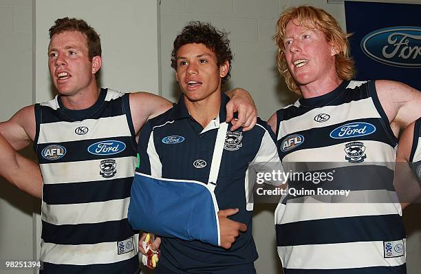 Steve Johnson, Steven Motlop and Cameron Ling of the Cats sing the song in the rooms after winning the round two AFL match between the Hawthorn Hawks...