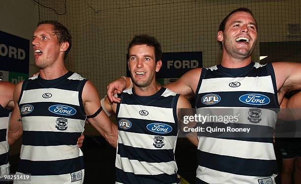 James Kelly, Shannon Byrnes and Josh Hunt of the Cats sing the song in the rooms after winning the round two AFL match between the Hawthorn Hawks and...