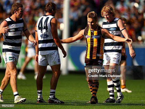 Sam Mitchell of the Hawks gestures to Corey Enright of the Cats during the round two AFL match between the Hawthorn Hawks and the Geelong Cats at...