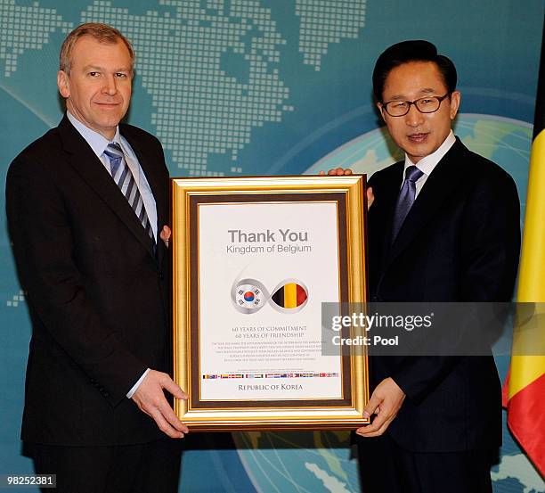 South Korean President Lee Myung-Bak delivers a letter of thanks for participation in the 1950-53 Korean war to Belgian Prime Minister Yves Leterme...