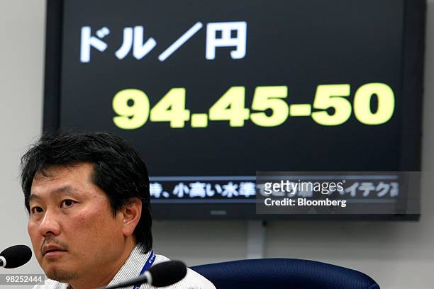Dealer works at a foreign exchange brokerage in Tokyo, Japan, on Monday, April 5, 2010. The dollar traded near the strongest level in more than seven...