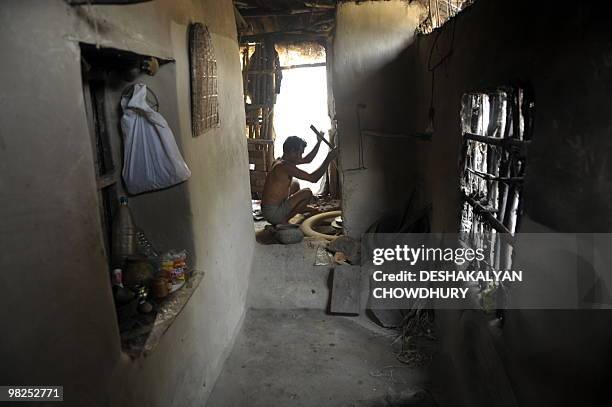 An Indian villager makes earthen pots at a village near Lalgarh, some 130 kms west of Kolkata, on April 5, 2010. Indian Home Minister P. Chidambaram...