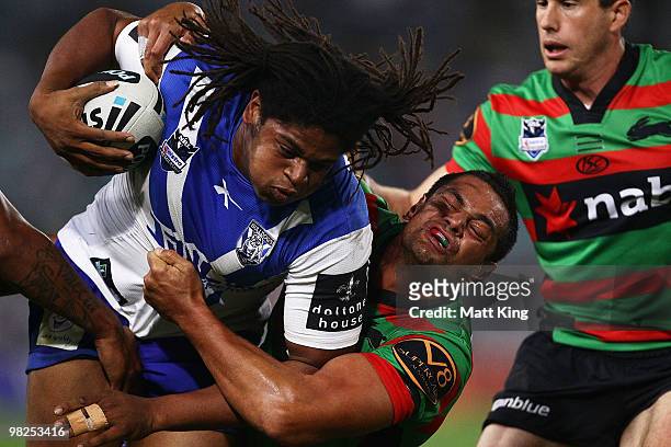 Jamal Idris of the Bulldogs is tackled by John Sutton of the Rabbitohs during the round four NRL match between the South Sydney Rabbitohs and the...