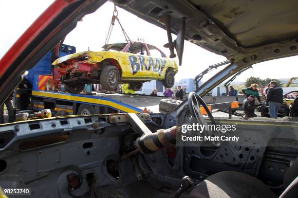 Banger racers work on their cars that have just finished a heat at the United Downs Raceway in St Day near Redruth on April 4, 2010 in Cornwall,...