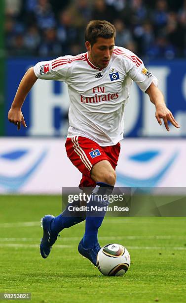 Tunay Torun of Hamburg runs with the ball during the Bundesliga match between Hamburger SV and Hannover 96 at HSH Nordbank Arena on April 4, 2010 in...