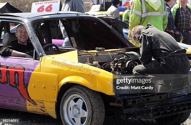 Mechanics try to get a car ready for another heat at the United Downs Raceway banger racing meet in St Day near Redruth on April 4, 2010 in Cornwall,...