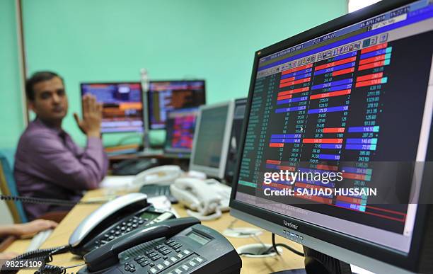 An Indian stock trader trades at a brokerage firm in Mumbai on April 5, 2010. Indian shares rose 1.37 percent on Monday, an over two-year-high, on...